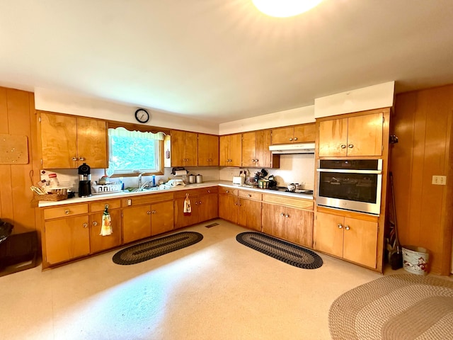 403 N Columbus St, Somerset, OH 43783 - kitchen with oven, under cabinet range hood, brown cabinetry, and light countertops