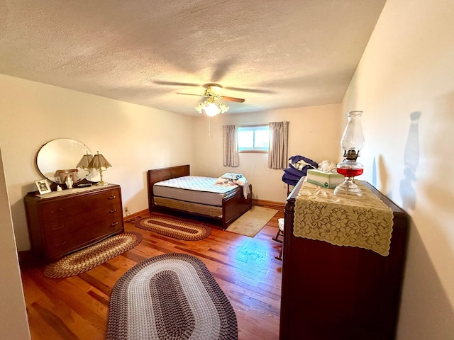 403 N Columbus St, Somerset, OH 43783 - bedroom featuring wood finished floors, a textured ceiling, and ceiling fan