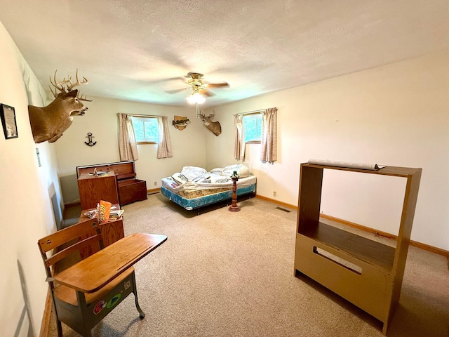 403 N Columbus St, Somerset, OH 43783 - bedroom featuring carpet floors, multiple windows, ceiling fan, and a textured ceiling