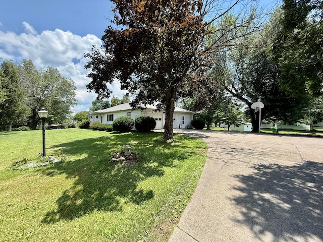 403 N Columbus St, Somerset, OH 43783 - view of front of house featuring concrete driveway, a front yard, and a garage