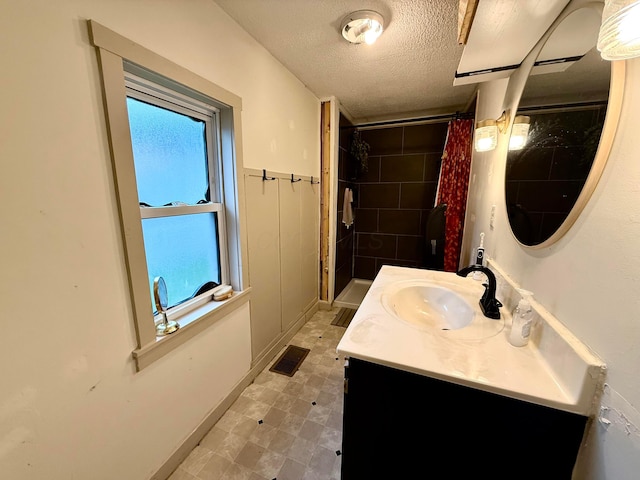 205 Sherman Ave, Lancaster, OH 43130 - full bathroom featuring vanity, tiled shower, a textured ceiling, and tile patterned floors