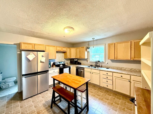 205 Sherman Ave, Lancaster, OH 43130 - kitchen featuring stainless steel appliances, light brown cabinetry, light countertops, and a textured ceiling
