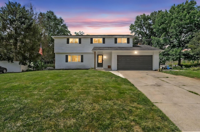 620 Fleetrun Ave, Columbus, OH 43230 - view of front facade featuring driveway, a yard, stucco siding, and an attached garage