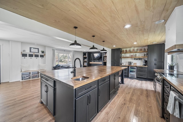 620 Fleetrun Ave, Columbus, OH 43230 - kitchen with wooden counters, beverage cooler, stainless steel electric range oven, light wood-type flooring, and pendant lighting