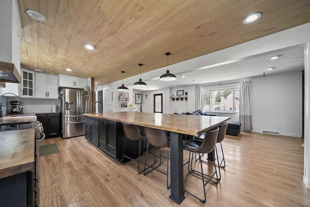 620 Fleetrun Ave, Columbus, OH 43230 - kitchen with butcher block counters, stainless steel appliances, wooden ceiling, dark cabinets, and a kitchen bar