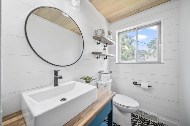 620 Fleetrun Ave, Columbus, OH 43230 - half bathroom featuring wooden ceiling, vanity, and wood walls