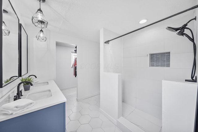 620 Fleetrun Ave, Columbus, OH 43230 - bathroom with a tile shower, tile patterned floors, double vanity, and a textured ceiling