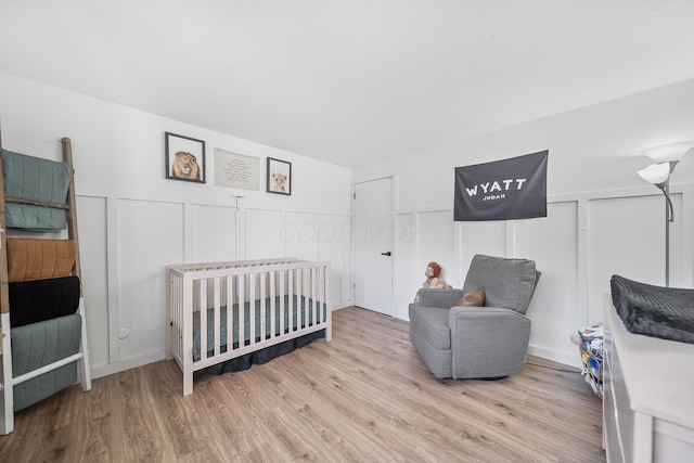 620 Fleetrun Ave, Columbus, OH 43230 - bedroom featuring wood finished floors, a decorative wall, and a wainscoted wall