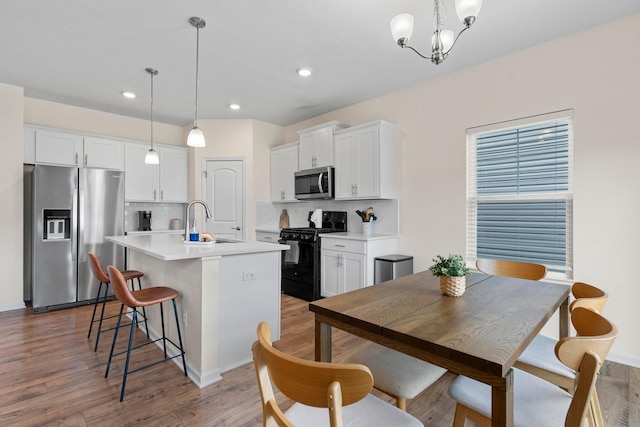 507 Curry Dr, Pataskala, OH 43062 - kitchen with appliances with stainless steel finishes, white cabinets, tasteful backsplash, wood finished floors, and recessed lighting