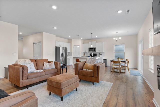 507 Curry Dr, Pataskala, OH 43062 - living area with light wood-type flooring, a chandelier, and recessed lighting