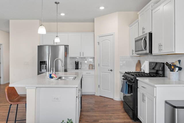 507 Curry Dr, Pataskala, OH 43062 - kitchen with appliances with stainless steel finishes, dark wood-type flooring, a kitchen bar, tasteful backsplash, and white cabinets