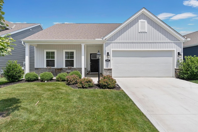 507 Curry Dr, Pataskala, OH 43062 - view of front of home with stone siding, a front yard, a garage, and driveway