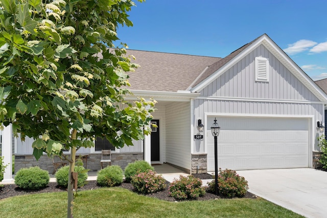 507 Curry Dr, Pataskala, OH 43062 - view of front facade featuring a shingled roof, an attached garage, concrete driveway, and board and batten siding
