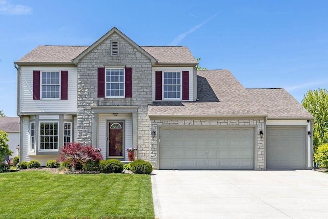 4384 Marilyn Dr, Lewis Center, OH 43035 - view of front of house with stone siding, concrete driveway, a front lawn, roof with shingles, and an attached garage