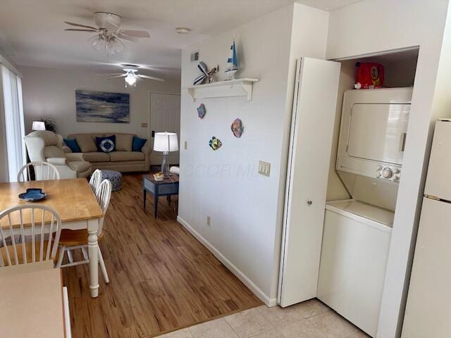 241 Chase Ave Unit B1L, Russells Point, OH 43348 - dining area featuring stacked washer / dryer, ceiling fan, and light tile patterned floors