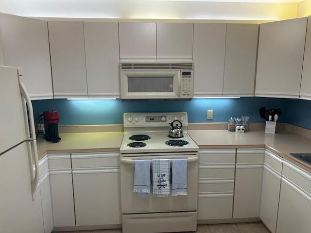 241 Chase Ave Unit B1L, Russells Point, OH 43348 - kitchen featuring white appliances and light countertops