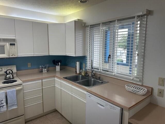 241 Chase Ave Unit B1L, Russells Point, OH 43348 - kitchen featuring white appliances, light countertops, and light tile patterned floors