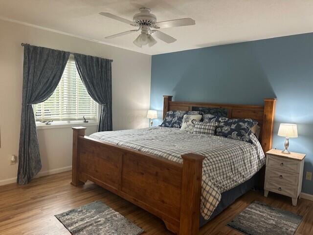 241 Chase Ave Unit B1L, Russells Point, OH 43348 - bedroom with wood finished floors and a ceiling fan