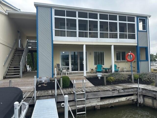 241 Chase Ave Unit B1L, Russells Point, OH 43348 - rear view of house featuring stairs and a water view