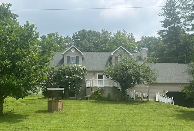 531 Cox Rd, Chillicothe, OH 45601 - back of house featuring a yard, a chimney, a garage, roof with shingles, and a deck
