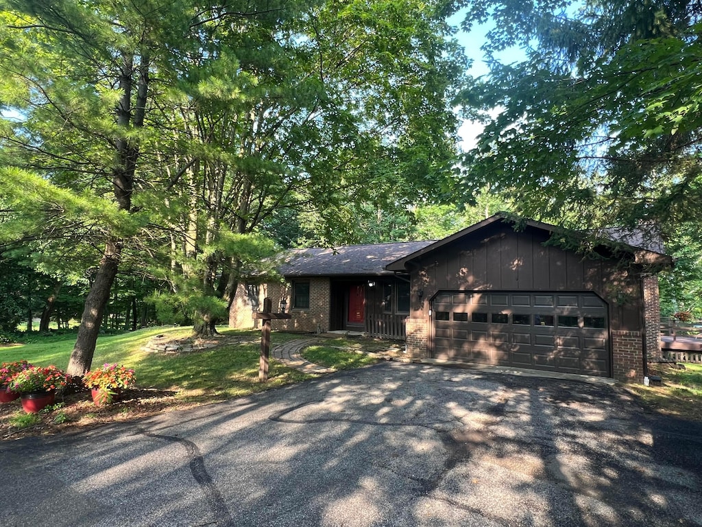 3502 Hazelton Etna Rd, Alexandria, OH 43001 - view of front of house featuring driveway, brick siding, a garage, and a front yard