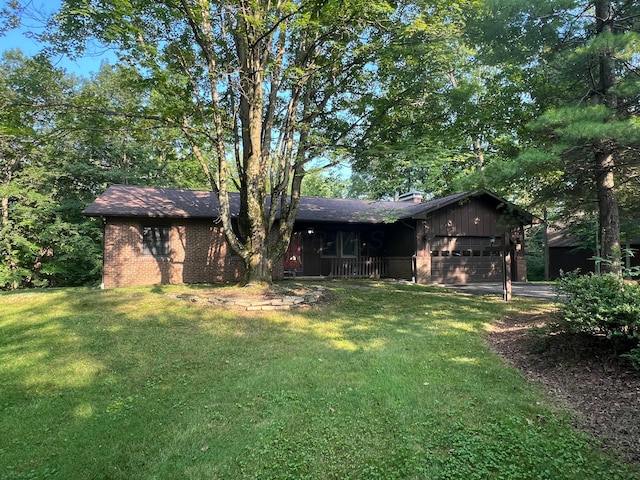 3502 Hazelton Etna Rd, Alexandria, OH 43001 - back of house with a yard, a garage, brick siding, a chimney, and driveway