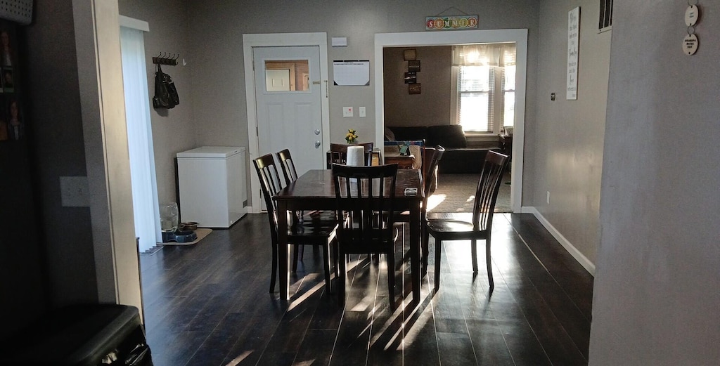 316 N High St, Caledonia, OH 43314 - dining space with dark wood-type flooring and baseboards