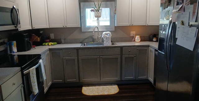 316 N High St, Caledonia, OH 43314 - kitchen with appliances with stainless steel finishes, light countertops, and dark wood-type flooring