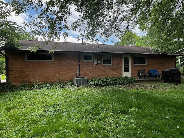 6942 Bartlett Rd, Reynoldsburg, OH 43068 - rear view of house featuring brick siding, a patio, and a lawn
