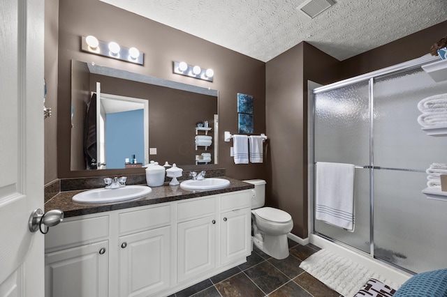 5466 Bull Creek Dr Unit 101, Dublin, OH 43016 - full bath with double vanity, a stall shower, a textured ceiling, and tile patterned floors