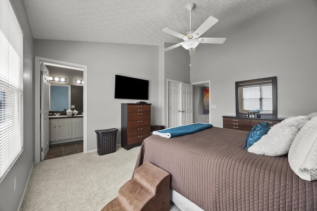 5466 Bull Creek Dr Unit 101, Dublin, OH 43016 - bedroom featuring carpet flooring, a textured ceiling, ensuite bath, ceiling fan, and high vaulted ceiling