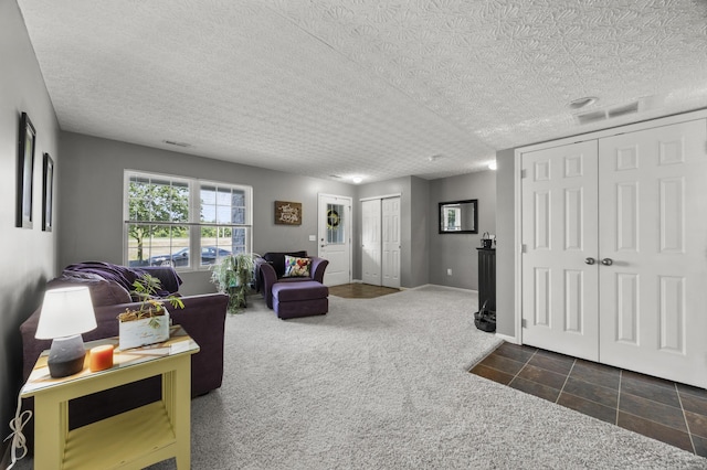 5466 Bull Creek Dr Unit 101, Dublin, OH 43016 - carpeted living area featuring a textured ceiling and tile patterned flooring