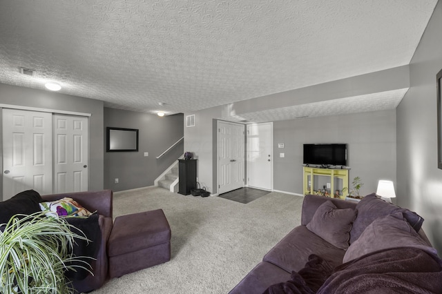 5466 Bull Creek Dr Unit 101, Dublin, OH 43016 - carpeted living room with stairway and a textured ceiling