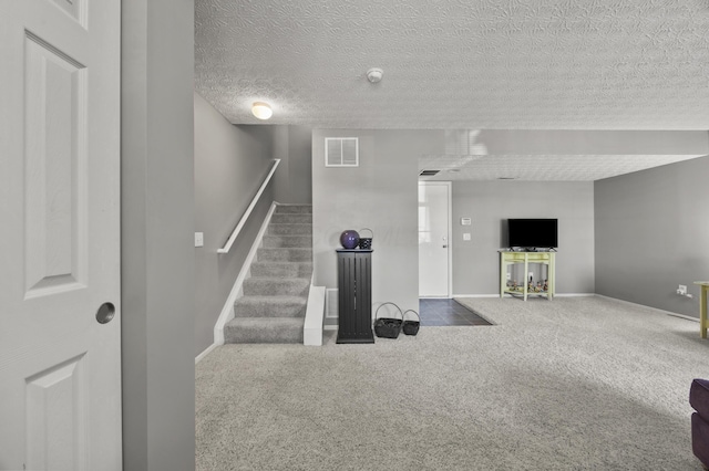5466 Bull Creek Dr Unit 101, Dublin, OH 43016 - unfurnished living room with stairway, carpet floors, and a textured ceiling
