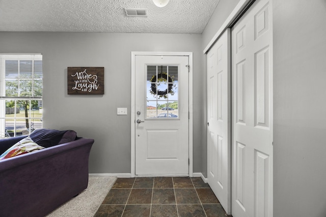 5466 Bull Creek Dr Unit 101, Dublin, OH 43016 - entrance foyer with a textured ceiling and dark stone finish floors