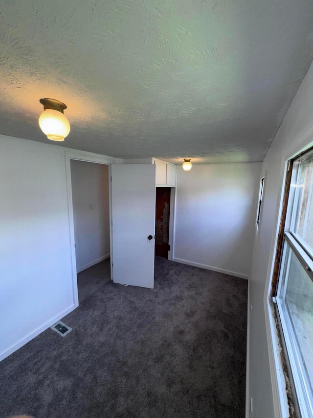 2229 Maureen Blvd N, Obetz, OH 43207 - spare room with dark carpet and a textured ceiling