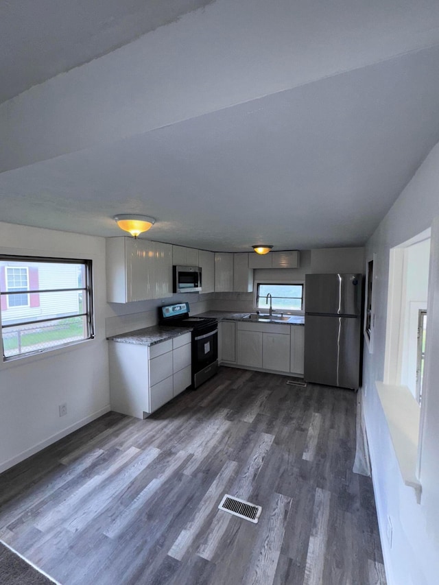 2229 Maureen Blvd N, Obetz, OH 43207 - kitchen with stainless steel appliances, dark wood-style floors, and white cabinetry