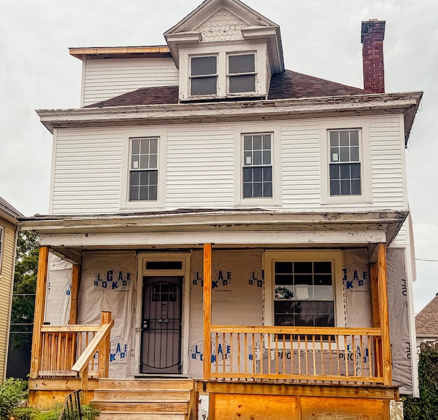 701 S 22nd St, Columbus, OH 43205 - view of front of property with covered porch, a shingled roof, and a chimney