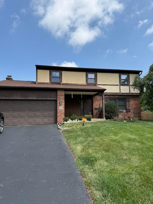 1258 Denbigh Dr, Columbus, OH 43220 - traditional home with brick siding, driveway, and stucco siding