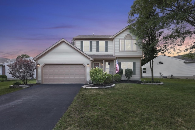 8512 Squad Dr, Galloway, OH 43119 - traditional-style home with driveway, a garage, and a lawn
