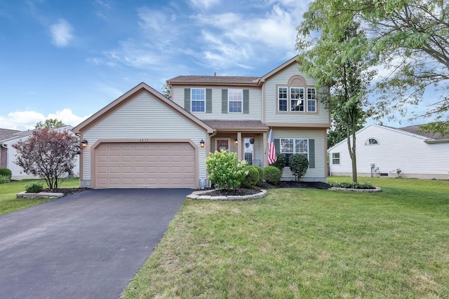 8512 Squad Dr, Galloway, OH 43119 - traditional-style house featuring driveway, an attached garage, and a front lawn