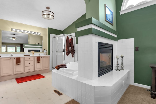 8512 Squad Dr, Galloway, OH 43119 - bathroom with a fireplace, lofted ceiling, a shower stall, a garden tub, and double vanity