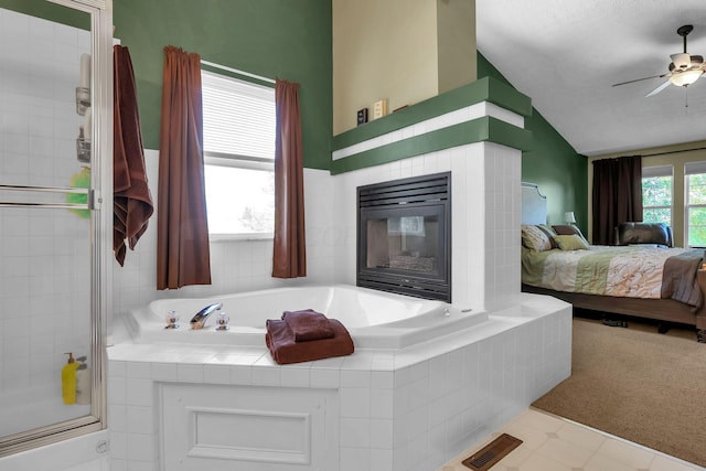 8512 Squad Dr, Galloway, OH 43119 - ensuite bathroom with lofted ceiling, a garden tub, ceiling fan, and a fireplace