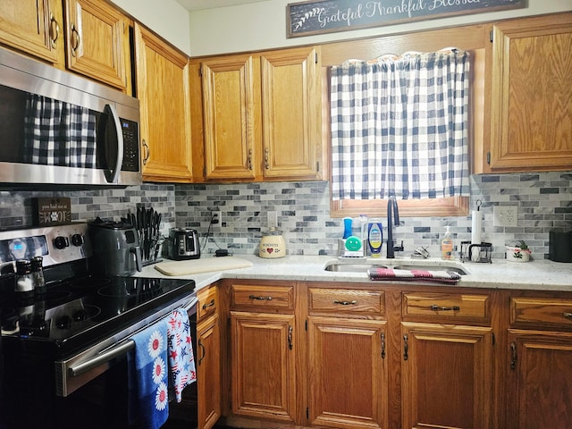 112 N George St, Lancaster, OH 43130 - kitchen with electric range oven, stainless steel microwave, decorative backsplash, and brown cabinets
