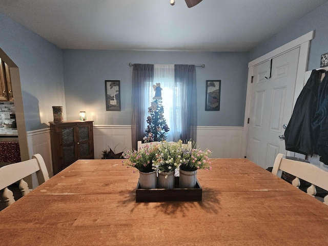 112 N George St, Lancaster, OH 43130 - dining space with a wainscoted wall, a ceiling fan, and a decorative wall