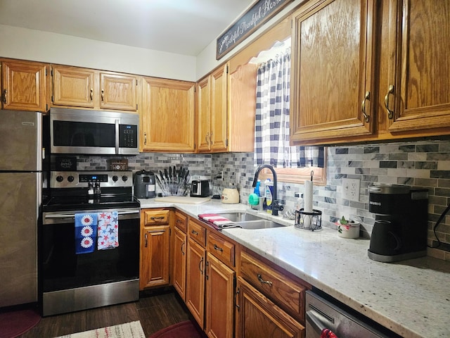 112 N George St, Lancaster, OH 43130 - kitchen featuring stainless steel appliances, tasteful backsplash, dark wood-type flooring, light stone counters, and brown cabinetry