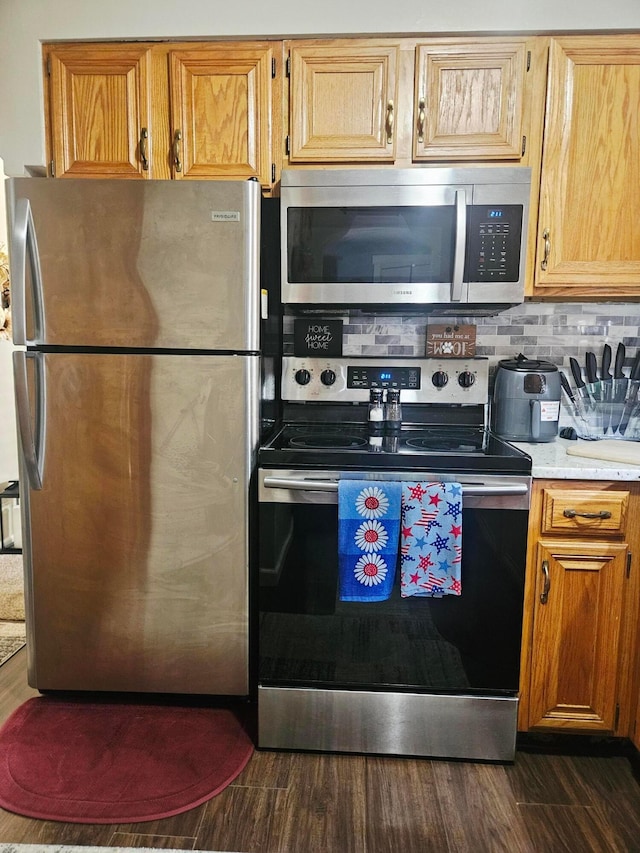 112 N George St, Lancaster, OH 43130 - kitchen with appliances with stainless steel finishes, light countertops, dark wood-style flooring, and backsplash