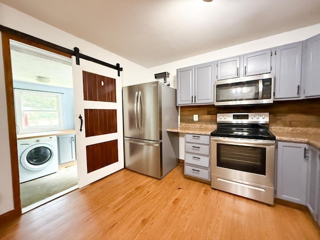 206 William St, Fulton, OH 43321 - kitchen featuring stainless steel appliances, washer / dryer, and gray cabinets