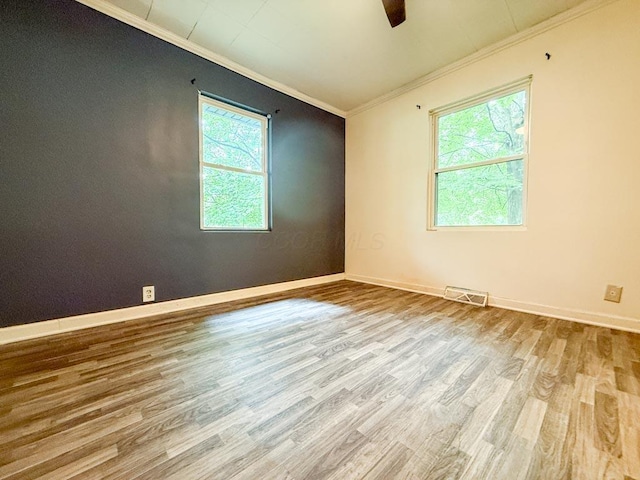206 William St, Fulton, OH 43321 - empty room featuring crown molding, wood finished floors, and a ceiling fan