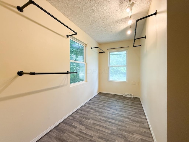 206 William St, Fulton, OH 43321 - empty room with a textured ceiling and dark wood-style flooring